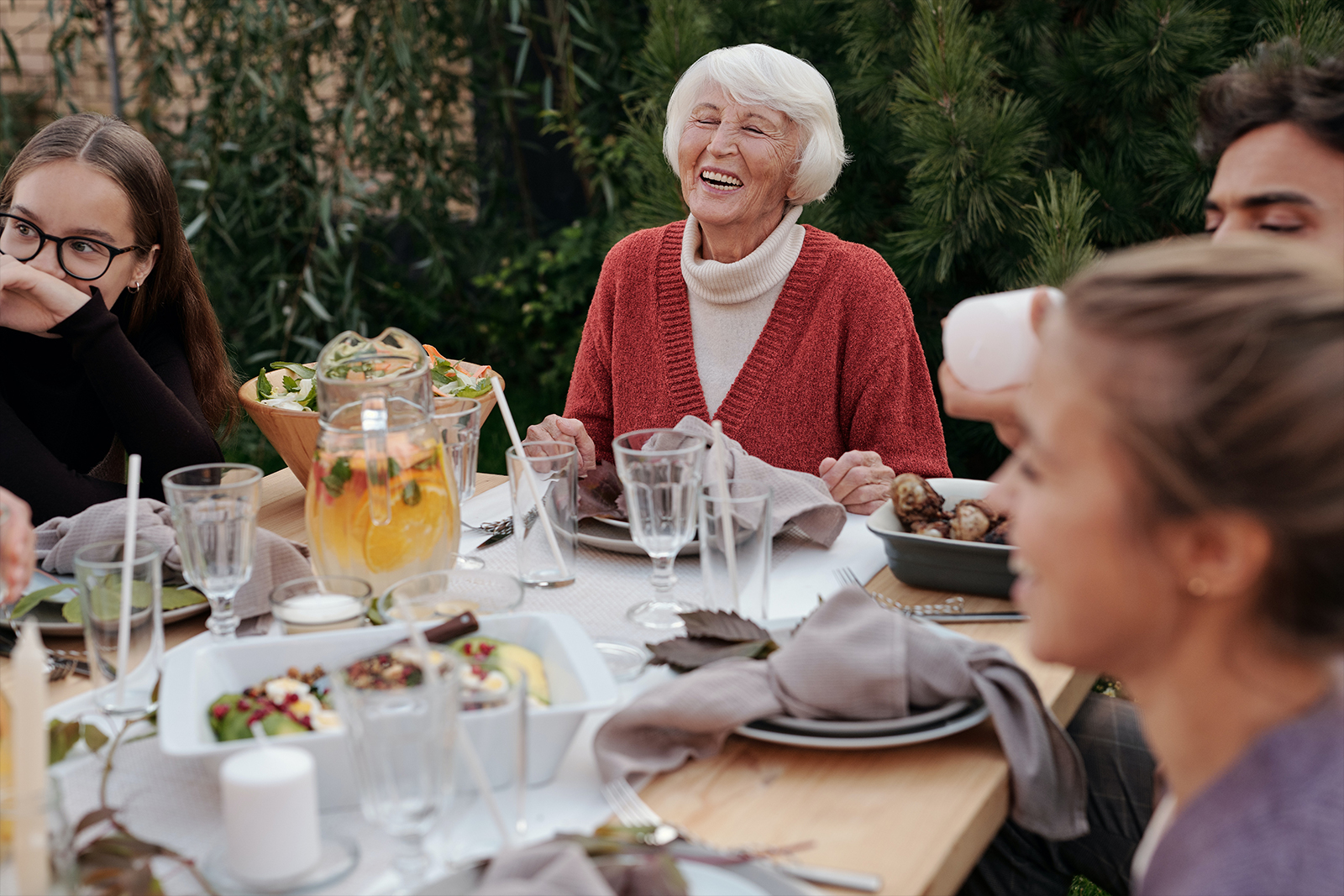 Older woman laughing at dinner